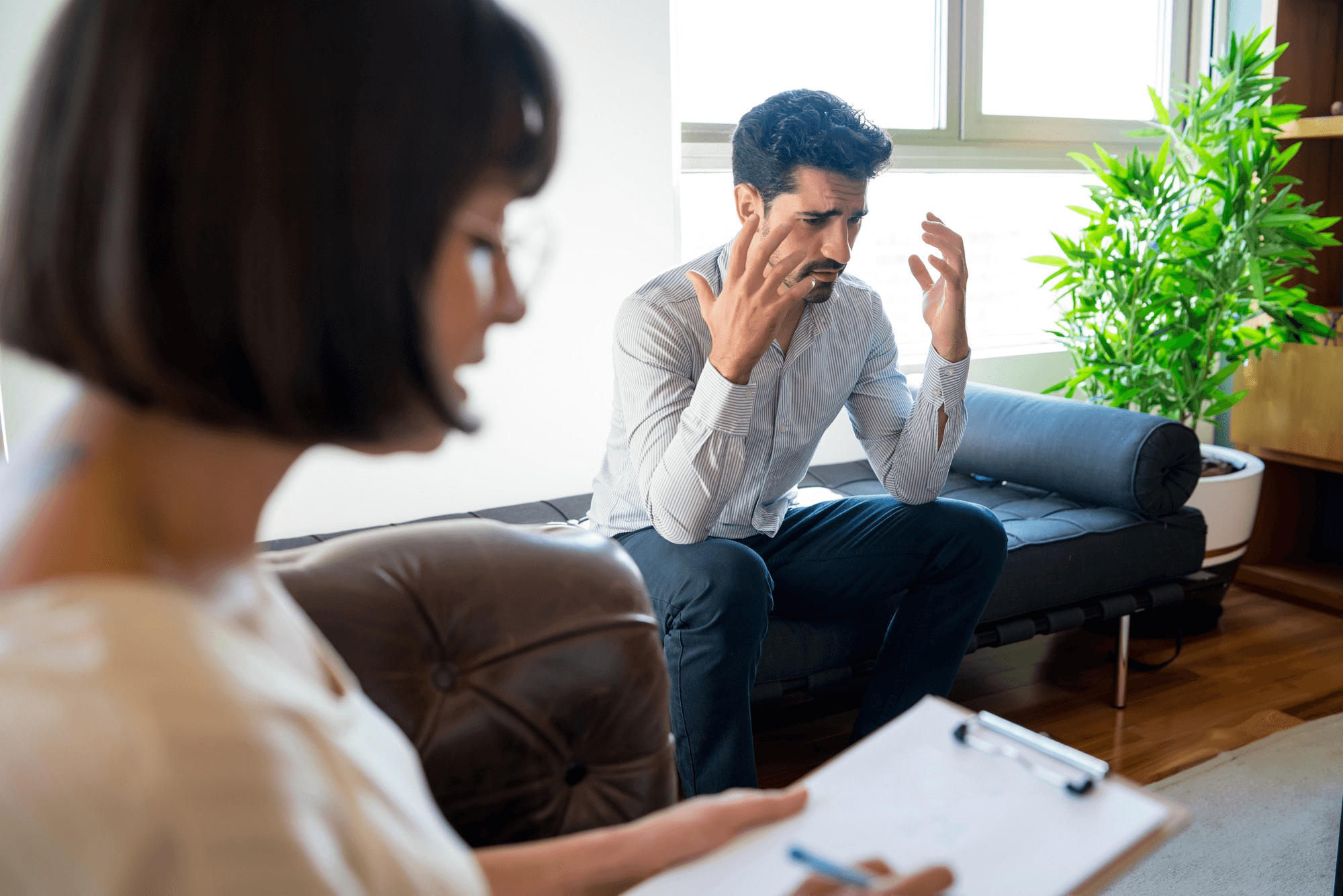 Man attending therapy session for mental health insurance coverage.